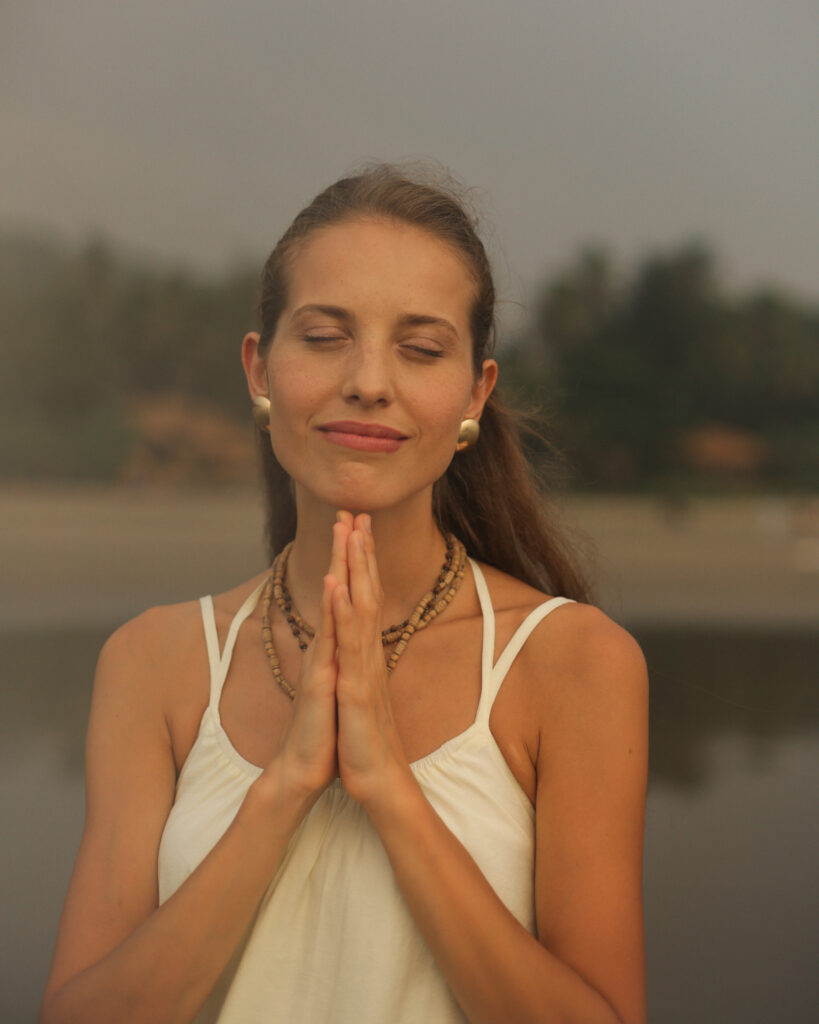 Confident woman smiling, embodying self-worth and lightness.